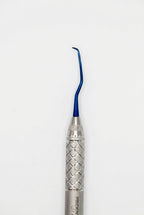 A dental hand instrument with a textured silver handle and a curved blue metal tip, shown vertically against a plain light gray background.
